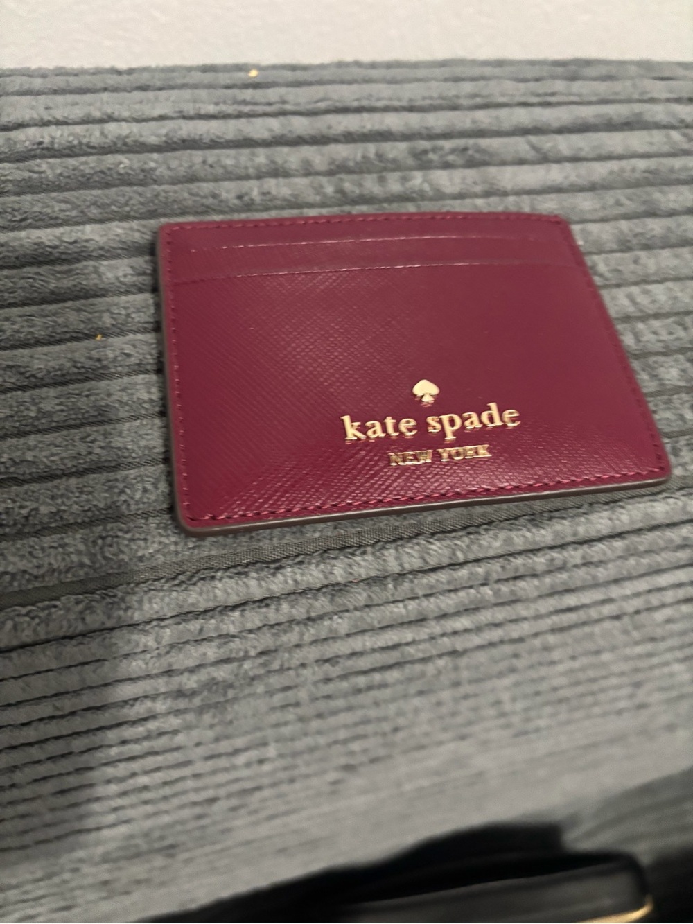 kate spade plum card case with gold logo
